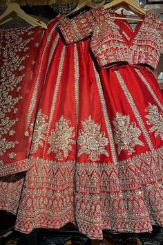 Red attached cancan flared lehenga with floral embroidery using mix material of dabka dori, sitara sequins, zari, beads and pearls. Paired with a padded blouse with embroidery using similar work and a belt with coordinating mobile packet. Comes along with a veil dupatta with embroidered and kiran lace border and a second dupatta with dabka, sitara embroidery. - Aza Fashions Red Anarkali Sets For Reception, Red Floor-length Sets For Reception, Red Gown With Dori Work For Traditional Ceremonies, Red Semi-stitched Sets For Traditional Ceremonies, Red Fitted Lehenga For Traditional Ceremonies, Red Floor-length Sets With Dupatta, Red Cutdana Sets For Traditional Ceremonies, Red Floor-length Sets For Festivals, Red Embroidered Sets For Navratri