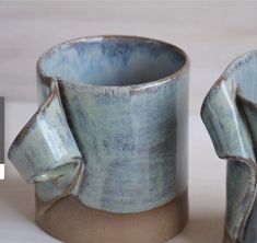 two blue vases sitting next to each other on a table