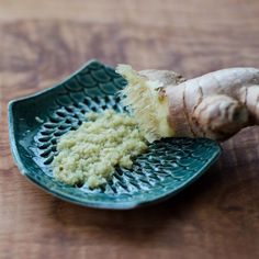 a close up of a piece of broccoli on a plate with the roots still attached