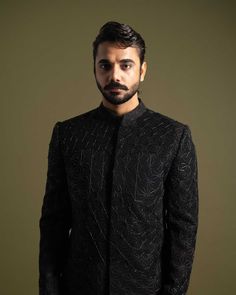 The Achkan is a marvel of tailoring, made from premium black suiting fabric. It features an intricate floral geometric pattern, brought to life with leather cord, thread, and Cutdana embroidery. This detailed workmanship creates a texture that is both visually striking and sophisticated.

Size Chart For Men





	
	
					Men's Size Chart
		

		
		
						
				Size Chart For Men
				Custom Size Measurement Guide
			
			
				
				
				Custom Size Measurement Guide
1. Take your measurements at ease… Traditional Bandhgala With Geometric Embroidery For Eid, Festive Bandhgala With Geometric Embroidery For Eid, Festive Eid Bandhgala With Geometric Embroidery, Designer Embroidered Bandhgala For Semi-formal Occasions, Designer Embroidered Bandhgala For Semi-formal Events, Designer Black Nehru Jacket For Ceremonial Occasions, Designer Nehru Jacket With Resham Embroidery For Formal Events, Designer Black Bandhgala For Festive Season, Designer Black Bandhgala For Festive Occasions