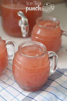 three mugs filled with ice tea on top of a table