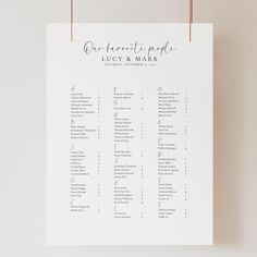 a wedding seating chart hanging on a wall