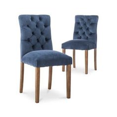 pair of blue velvet dining chairs with wooden legs and buttoned backrests on white background