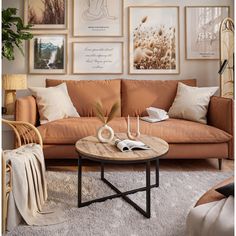 a living room filled with furniture and pictures on the wall above it's coffee table