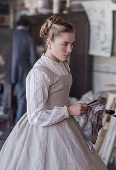 a woman dressed in an old fashion dress