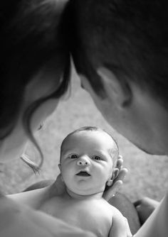 a woman holding a baby in her arms