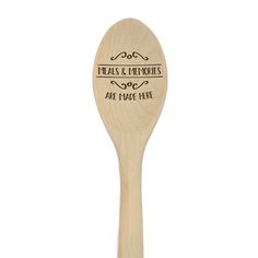 a wooden spoon with an engraved message on the side and words that read, heals & soothes are made here