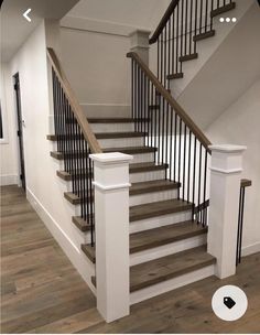 a staircase with wooden handrails and white railing