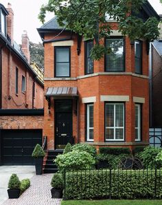 a brick house with black doors and windows