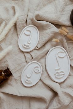 three cookie cutters sitting on top of a white sheet