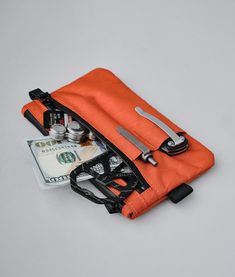 Rugged and compact, this clutch comes in weatherproof sailcloth fabric. Practical and functional, it allows you to keep your essentials always at hand.This clutch also comes with a detachable hand strap, so you can easily carry it when you need to. As a bonus, it comes with three external slots for additional space to carry a phone, pen, a small torch, etc. Functional Pouch With Zipper Pocket For Everyday, Functional Everyday Pouch With Zipper Pocket, Functional Nylon Pouch For Everyday Use, Functional Everyday Zipper Pouch, Functional Everyday Pouch With Cell Phone Pocket, Functional Travel Pouch With Zipper Pocket, Functional Nylon Pouch For Daily Use, Everyday Functional Pouch With Zipper Pocket, Multifunctional Pouch With Zipper Pocket For Outdoor