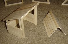 a wooden bench and chair made out of popsicle sticks sitting on the floor next to each other