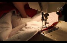 the sewing machine is being used to sew something on it's surface,