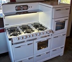 an old fashioned white stove and oven in a kitchen