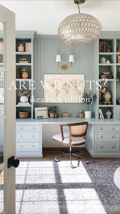 a home office with built in bookcases and drawers