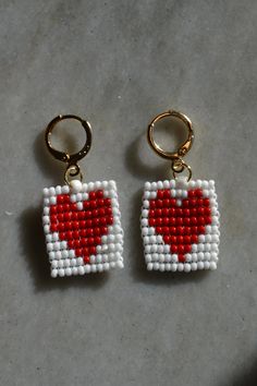 two pairs of beaded earrings with hearts on them