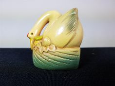 a small ceramic bird sitting on top of a table