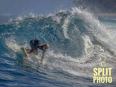 a man riding a wave on top of a surfboard