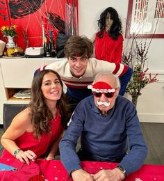 an older man sitting next to two young women