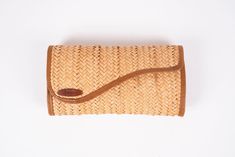 Embrace natural elegance with our exquisite handmade palm leaf clutch. Crafted by skilled artisans, this unique accessory seamlessly blends sustainable materials and timeless design. The palm leaf exterior, measuring 26 cm in length and 15 cm in height, exudes rustic charm, while the genuine leather accents add a touch of sophistication. Whether you're strolling through a bustling market or attending a garden party, this clutch effortlessly complements your style. Its compact size ensures it hol Traditional Handmade Beach Clutch, Elegant Handmade Natural Clutch, Handmade Brown Clutch Pouch, Natural Woven Rectangular Pouch, Bohemian Handmade Clutch In Natural Color, Handwoven Brown Clutch For Travel, Handmade Brown Rectangular Clutch, Bohemian Brown Woven Clutch, Elegant Natural Clutch For Travel