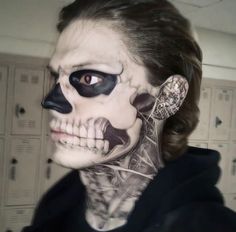 a woman with her face painted like a skeleton