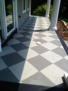 a white and black checkered floor in front of a house