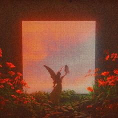 an angel statue in front of a window with red flowers around it and the sun shining through