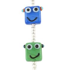 two blue and green square shaped beads with eyes on each bead, hanging from a silver chain