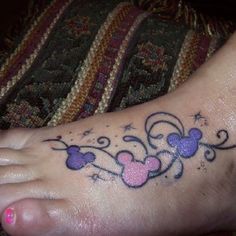 the foot has a mickey mouse tattoo on it