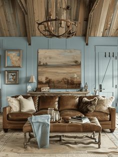 a living room filled with furniture and a chandelier hanging above the couches