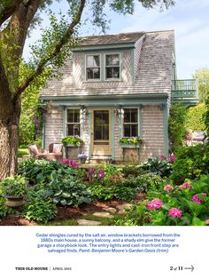 a house that is surrounded by flowers and trees