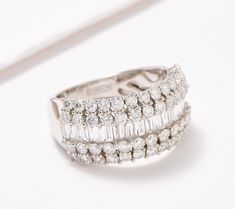 a diamond ring on a white surface