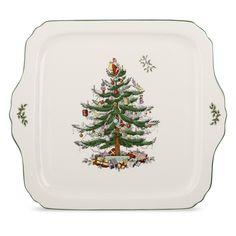 a white plate with a christmas tree on the front and green trimmings around it