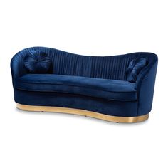 a blue velvet couch with gold trimmings on the arms and back, sitting in front of a white background