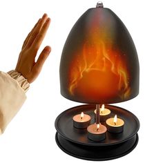 a hand is reaching out towards a lit candle holder with flames on it and the flame in the center