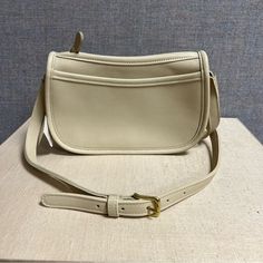 Vintage Coach “Wendie” In Bone Leather Crossbody Shoulder Bag 9031 Nwt. Zip Closure, 2 Interior Slip Pockets, 1 Exterior Slip Pocket, Adjustable Strap, Unlined. Brand New With Tag. Clean Inside. Minor Stains From Storage. Some Wear On Tag Chain. Please See All Pictures For Details As They Are Part Of The Description. Message Me If You Have Any Questions. Classic Rectangular Saddle Bag For Errands, Classic Saddle Bag For Errands, Elegant White Satchel Saddle Bag, Classic White Saddle Bag With Detachable Strap, Classic Crossbody Shoulder Bag For Errands, Timeless White Crossbody Shoulder Bag, Classic White Crossbody Saddle Bag, Beige Saddle Bag With Detachable Strap, Classic White Saddle Bag Satchel