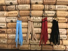 several different colored tassels hanging from cork