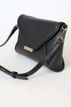 Lulus Exclusive! Nights out call for a bag that can keep up with your style, and that's where the Lulus That's Classy Black Clutch comes in! This sleek vegan leather clutch has unique seaming across the structured silhouette, plus a gold magnetic closure. Lift the front flap to reveal a zip-top interior with a zippered sidewall pocket. Adjustable crossbody strap included. Lined. Clutch measures 10" wide, 6" tall and 2. 5" deep (relaxed). Detachable 50. 5" adjustable strap. 100% PVC. Imported. Lu Chic Evening Clutch In Faux Leather, Chic Faux Leather Evening Clutch, Chic Evening Faux Leather Clutch, Elegant Faux Leather Travel Clutch, Chic Faux Leather Clutch For Everyday, Black Everyday Clutch With Fold Over Clasp, Black Clutch With Fold Over Clasp For Everyday Use, Leather Clutch With Detachable Strap For Night Out, Chic Black Soft Leather Clutch