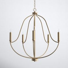 a gold chandelier with five candles hanging from the bottom and one light on top