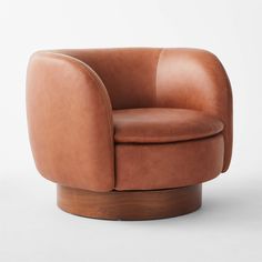 a brown leather chair sitting on top of a wooden base