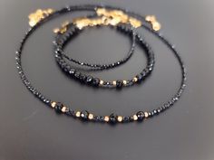 Lovely black set, chocker and 2 bracelets, made of natural black Spinel and Agate. Elegant black necklace made of   black 2mm micro faceted Spinal and natural Agate. Tiny bracelet made with small faceted 2mm Spinel beads. Black Agate bracelet made with 4mm faceted natural Agate beads. You might also like https://www.etsy.com/uk/shop/LoveIuliia?ref=l2-about-shopname§ion_id=42402163 Thank you so much for visiting my shop Iuliia xx Black Spiritual Jewelry With Faceted Beads, Black Jewelry With Faceted Beads For Gift, Handmade Black Onyx Bracelets, Handmade Onyx Black Bracelets, Black Round Beads Jewelry For Gifts, Minimalist Black Jewelry With Faceted Beads, Handmade Black Round Beads Jewelry, Minimalist Handmade Black Choker, Black Onyx Choker Jewelry