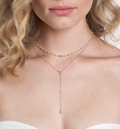 Pave-encircled cubic zirconia crystals adorn this stunning minimal lariat necklace. Lightweight design makes this piece comfortable to wear all day and night. Style with a strapless, off the shoulder, or sweetheart neckline gown for a fashion-forward bridal look. Rose Gold Vermeil 4mm Cubic Zirconia pave crystal Hypoallergenic, lead, and nickel free Chain Length: 16in (40.6cm) + Extension: 2in (5.1cm) Drop Height: 3in (7.6cm) #N321 Dainty Rose Gold Necklace, Layered Necklace Silver, Gold Bridal Necklace, Backdrops Necklace, Gold Lariat Necklace, Silver Wedding Jewelry, Layered Necklaces Silver, Bridesmaid Gifts Jewelry, Night Style