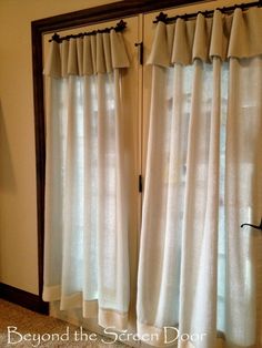 the curtains are hanging in front of the window