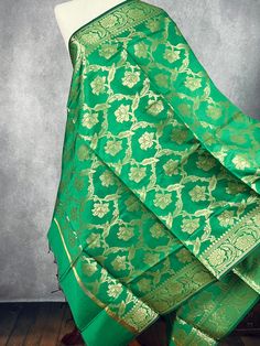 Beautiful GreenColor Floral dupatta with black color tassels. Dupatta has floral Jaal all over. Item: Dupatta Base color : Green with muted Gold Zari Fabric : Soft Silk (Not Pure Silk) Work : Zari Weaved with tassels Length of the Dupatta : 92 inches approx. Width of the dupatta : 35 1/2 inches (Approx.) Store Policies - No return or exchange will be accepted for color variations. - No return or exchange will be accepted if the color does not match your other clothing or your partners or anyone else. - Since this Dupatta is handmade hence little inconsistencies may be there however it is not considered as a defect. - Zari or thread coming out or on folds is not considered as defects. - Slight variation in actual color vs. image is possible due to the screen resolution. - For more Store pol Luxury Pista Green Dola Silk Dupatta, Designer Green Slub Silk Dupatta, Elegant Green Silk Dupatta, Green Unstitched Dola Silk Dupatta, Green Handloom Slub Silk Dupatta, Readymade Blouse, Silk Dupatta, Indian Wear, Pure Silk