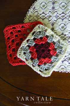 two crocheted coasters sitting on top of a wooden table