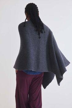 Stay comfortable and effortlessly fashionable with this versatile poncho that's ready to become your go-to choice for staying snug and stylish. Oversized fit Ribbed fabric Round neck Diagonal silhouette Draped sleeve Cozy Soft Knit Poncho For Layering, One Size Knit Poncho For Layering, One-size Gray Poncho For Layering, Layering Poncho In Soft Knit, Soft Knit Poncho For Layering, Cozy Oversized Cape For Cold Weather, Oversized Soft Knit Cozy Poncho, Cozy Oversized Soft Knit Poncho, Oversized Knit Poncho Shawl