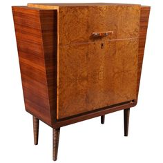 a wooden cabinet with two doors and legs