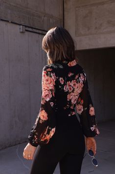 Effortlessly elevate your everyday look with our Flawless Florals Top. Featuring a beautiful floral print, button down design, and comfortable long sleeves, this top is perfect for any occasion. Add a touch of elegance to your wardrobe with this must-have piece. Fabric 100% polyester Elegant Black Floral Print Tops, Black Long Sleeve Top With Rose Print, Feminine Black Floral Print Top, Black Long Sleeve Floral Print T-shirt, Black Floral Print Top With 3/4 Sleeves, New Tops, Everyday Look, Dress Collection, American Girl