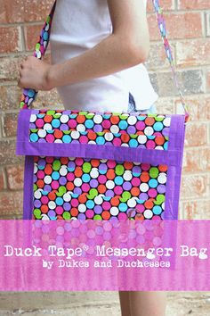 a woman holding a purple bag with polka dots on it and the words duct tape messenger bag