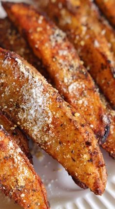 some fried carrots on a white plate covered in powdered sugar